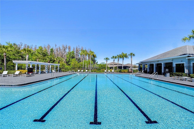 pool with a patio area, a pergola, and fence