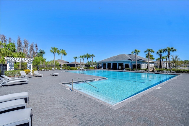 community pool featuring a patio, fence, and a pergola