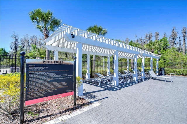 view of property's community featuring a pergola and fence