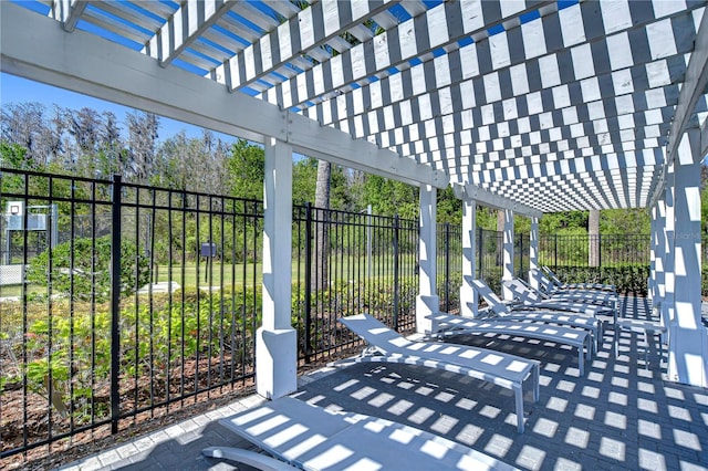 view of patio with a pergola and fence