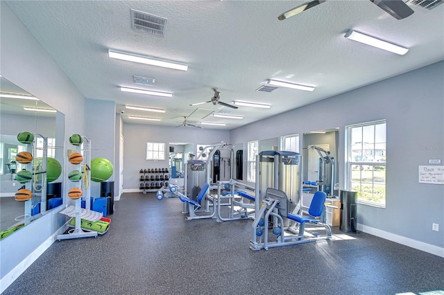 gym with visible vents, a textured ceiling, and baseboards