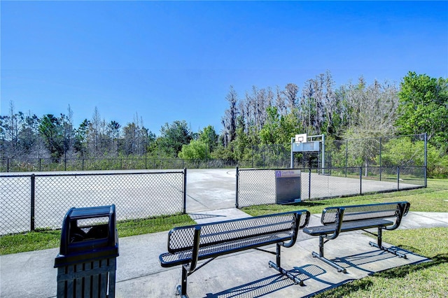 surrounding community featuring community basketball court and fence