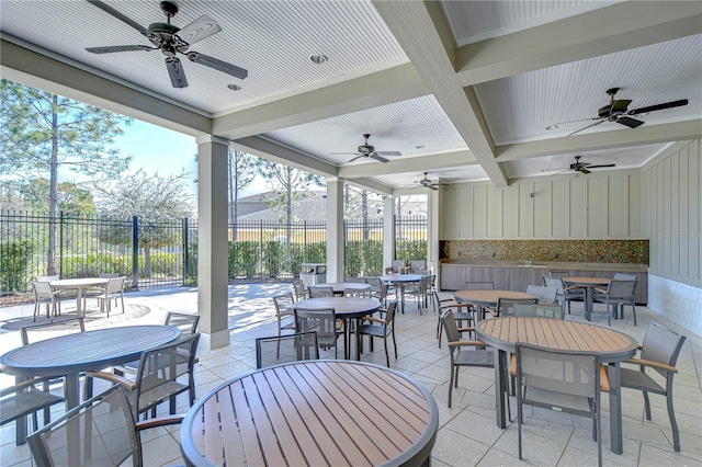 view of patio featuring outdoor dining space and fence