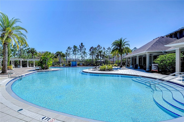 community pool with a patio and a pergola