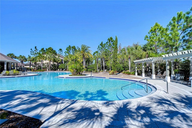 pool with a patio and a pergola