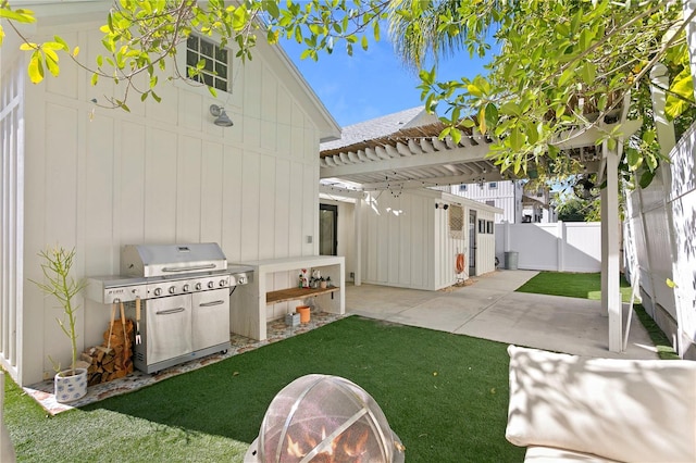 view of patio with fence, grilling area, and a pergola