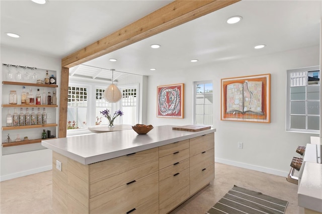 kitchen featuring baseboards, modern cabinets, light brown cabinets, beam ceiling, and recessed lighting