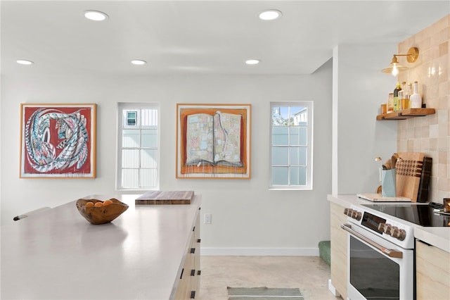 kitchen with stainless steel counters, white electric stove, baseboards, and recessed lighting