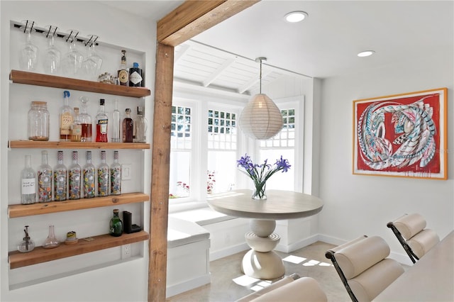 interior space featuring a dry bar, baseboards, breakfast area, beam ceiling, and recessed lighting