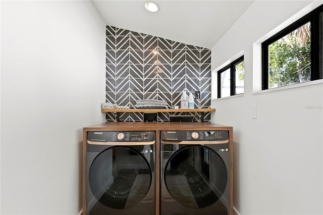 laundry room with laundry area, an accent wall, washer and clothes dryer, and recessed lighting