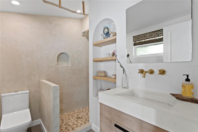 full bathroom featuring a walk in shower, built in shelves, vanity, and toilet