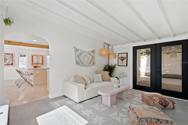 living room with baseboards, arched walkways, beam ceiling, and french doors