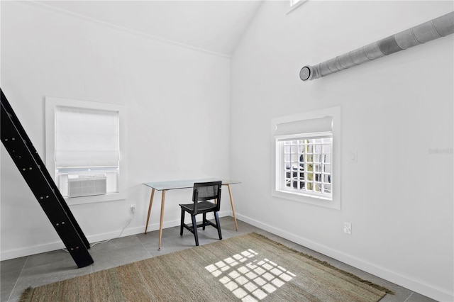 office with lofted ceiling, cooling unit, and baseboards