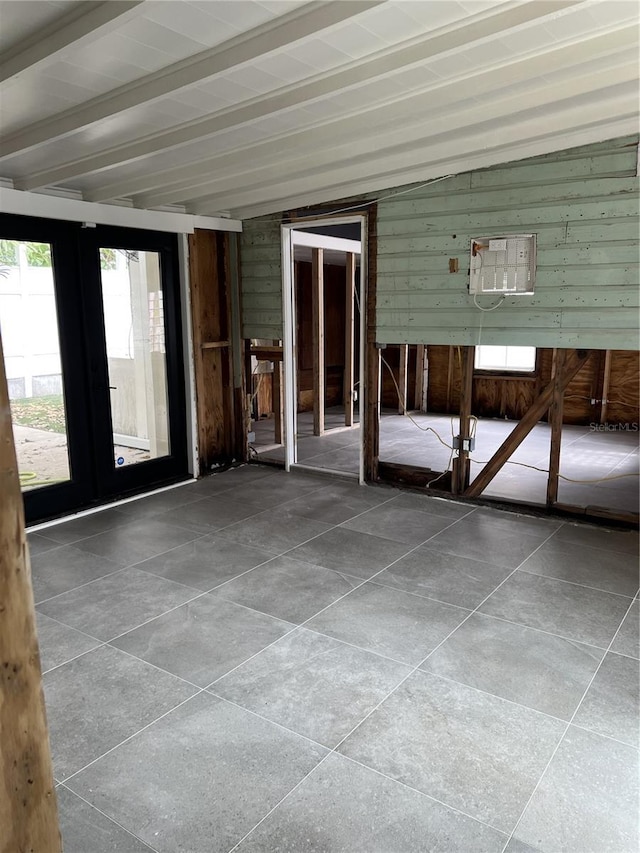 unfurnished sunroom with beamed ceiling