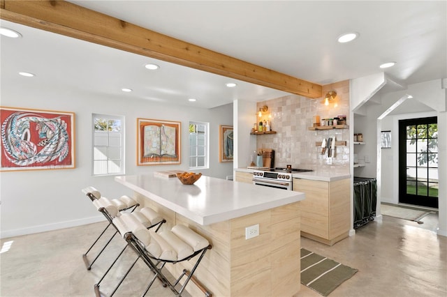 kitchen featuring recessed lighting, a breakfast bar, baseboards, tasteful backsplash, and beamed ceiling