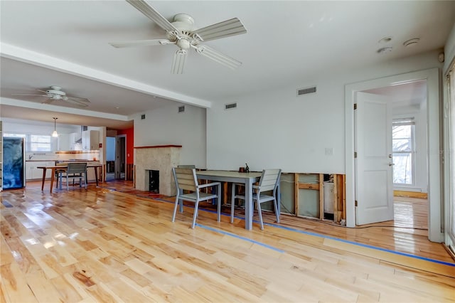 dining room featuring visible vents, a healthy amount of sunlight, and wood finished floors