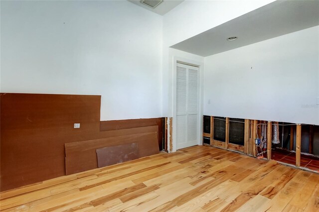 unfurnished room with visible vents and wood finished floors