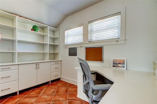 tiled office space featuring vaulted ceiling
