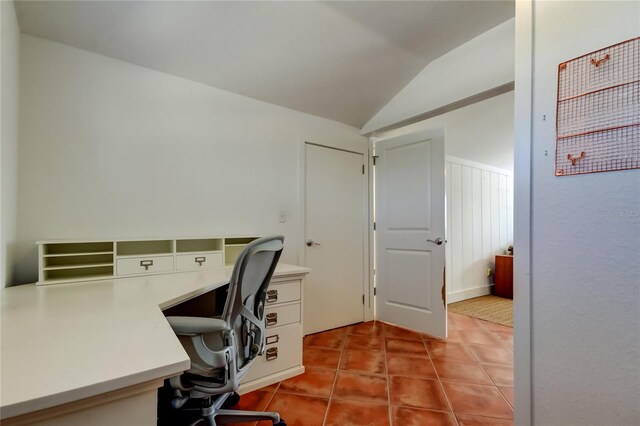 office area with lofted ceiling and light tile patterned floors