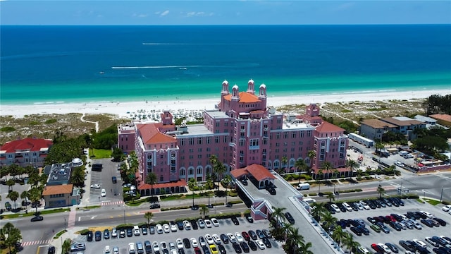drone / aerial view featuring a beach view and a water view