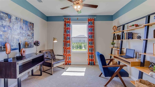 office area featuring carpet floors, visible vents, baseboards, and a ceiling fan