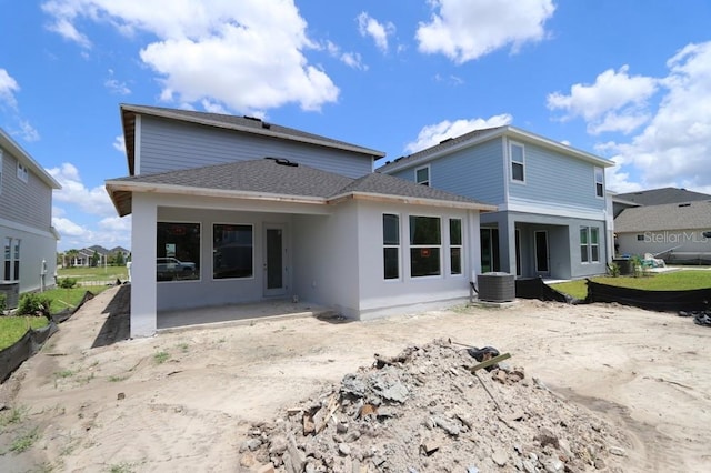 28740 Jujube Rd, Wesley Chapel, FL 33543 - rear view of house featuring a shingled roof, a patio, and central air condition unit