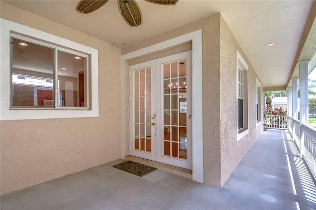 property entrance featuring french doors, a patio area, and stucco siding