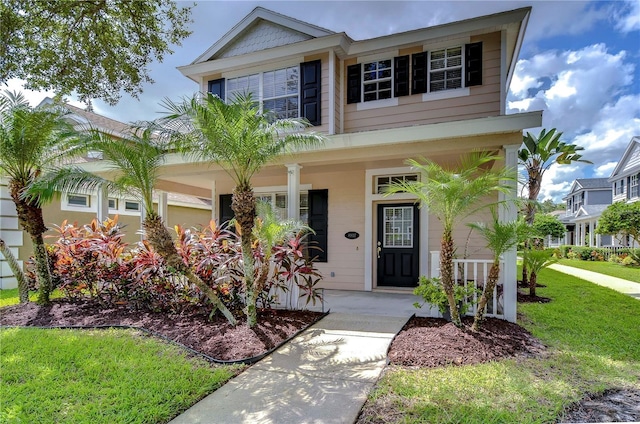 view of front facade with a front lawn and a porch