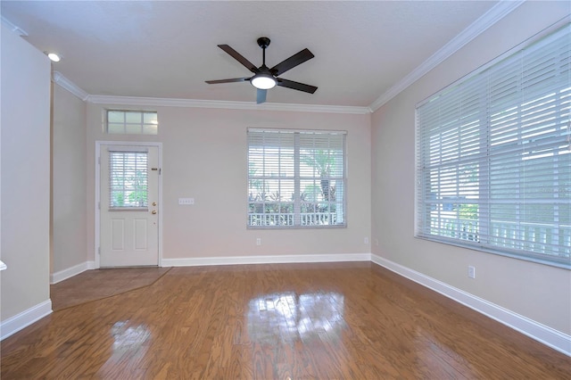 foyer entrance featuring ceiling fan, crown molding, baseboards, and wood finished floors