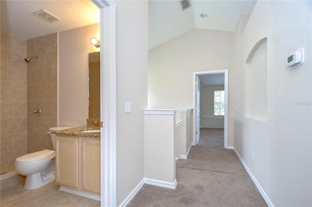 hallway with visible vents, vaulted ceiling, and baseboards