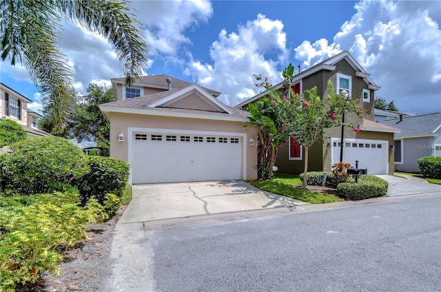 traditional-style house featuring driveway and stucco siding