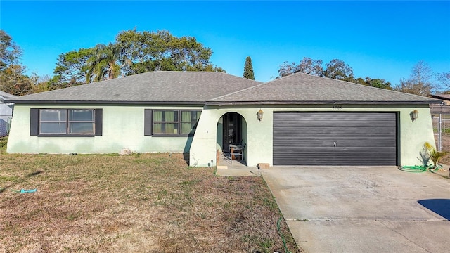 ranch-style home with a front lawn, an attached garage, driveway, and stucco siding