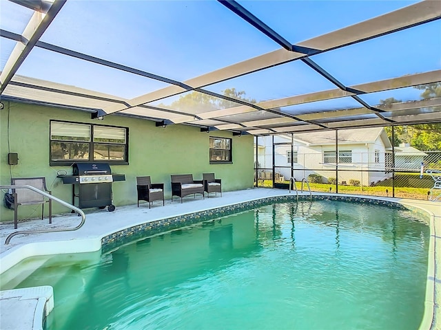 outdoor pool featuring a lanai, a patio area, and fence