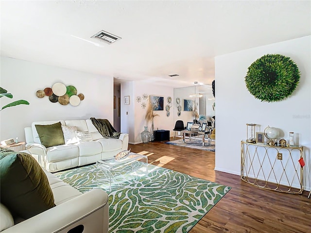 living area with visible vents and wood finished floors