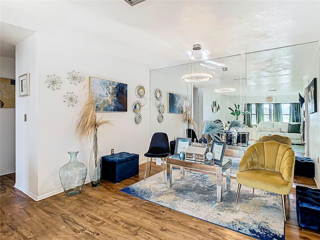 living area featuring wood finished floors and baseboards