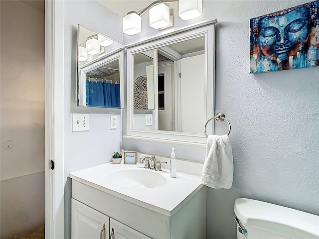 bathroom with toilet and vanity