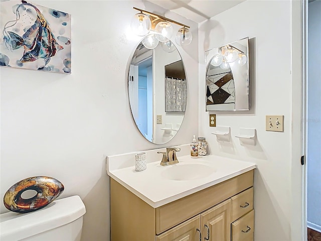 bathroom featuring toilet and vanity