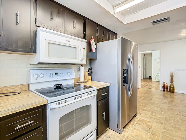 kitchen featuring decorative backsplash, white appliances, visible vents, and dark brown cabinetry