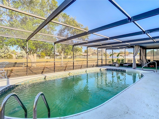 pool with glass enclosure, a patio, and fence