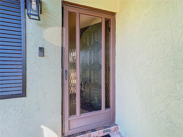 doorway to property with stucco siding