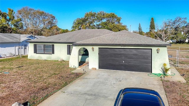 single story home with fence, roof with shingles, a front lawn, concrete driveway, and a garage