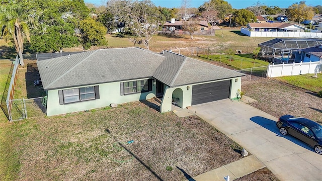 view of front of house featuring an attached garage, fence, driveway, and stucco siding