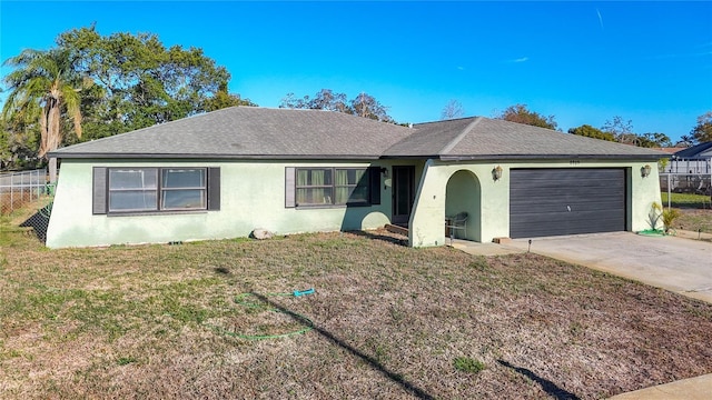 single story home featuring stucco siding, an attached garage, a front yard, and fence