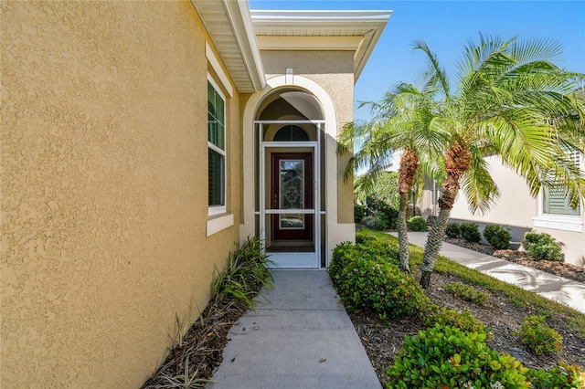 property entrance featuring stucco siding