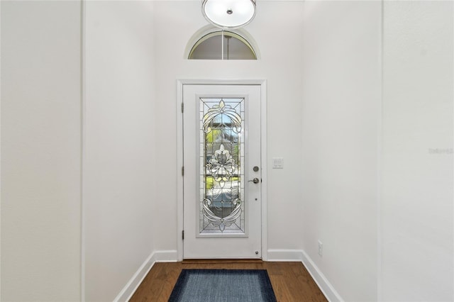 doorway to outside featuring dark wood finished floors and baseboards