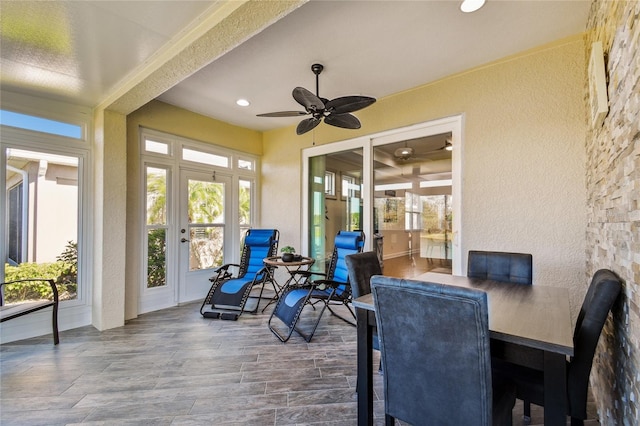 sunroom / solarium featuring a healthy amount of sunlight and ceiling fan