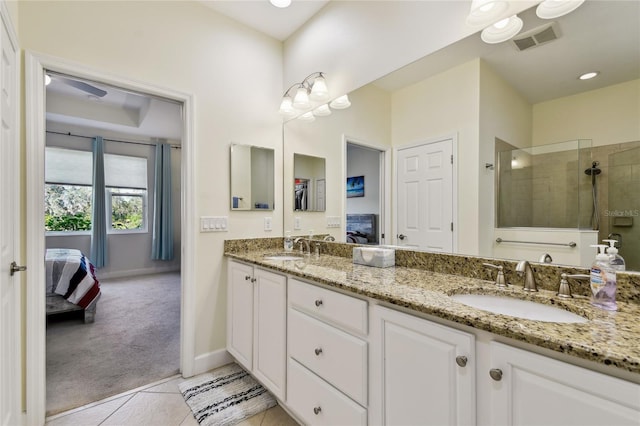 ensuite bathroom with a walk in shower, visible vents, ensuite bathroom, and a sink