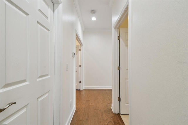 hall with crown molding, recessed lighting, baseboards, and light wood-type flooring