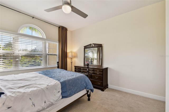 carpeted bedroom featuring a ceiling fan and baseboards