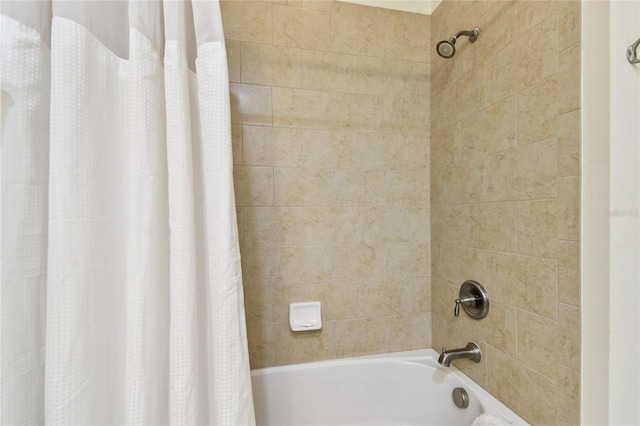 bathroom with shower / bath combo with shower curtain